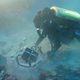 A scientist places an acrylic dome over the coral to be used in the staining experiment.